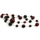 A LATE 19TH CENTURY CHERRY RED AMBER NECKLACE The spherical and oval cut beads with fine yellow