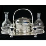 AN UNUSUAL SILVER PLATE AND ETCHED GLASS BISCUIT AND DECANTER SET Having a single carry handle,