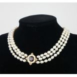 A VINTAGE 18CT GOLD AND FRESHWATER PEARL NECKLACE The oval 18ct gold clasp with three strands of