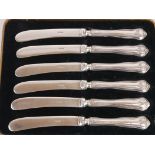 A CASED SET OF SILVER HANDLED BUTTER KNIVES With ribbon decoration, hallmarked Sheffield, 1933, in a