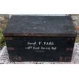 AN EARLY 20TH CENTURY RECTANGULAR MILITARY PINE TRAVEL TRUNK Having two carry handles, ebonised