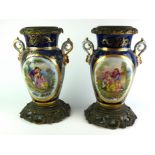 A PAIR OF CONTINENTAL PORCELAIN TWIN HANDLED VASES Both decorated to one side with gilded medallions