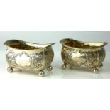 A PAIR OF GEORGIAN RECTANGULAR SILVER SALTS With embossed floral decoration, gilt interior and