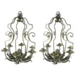 A PAIR OF WROUGHT IRON SIX BRANCH CHANDELIERS The scroll arms applied with leaves. (56cm x 43cm)