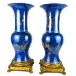 A PAIR OF CHIEN LONG CHINESE PORCELAIN BALUSTER VASES Powder blue with gilt decoration of various