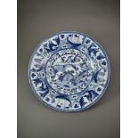 A BLUE AND WHITE KRAAK PLATE Transitional, well painted in centre with a seated scholar on a terrace