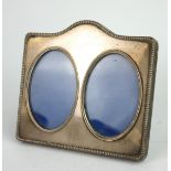 A VINTAGE PLAIN SILVER DOUBLE PHOTOGRAPH FRAME With gadrooned border and easel back, hallmarked