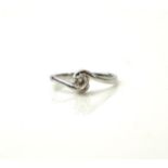 AN 18CT WHITE GOLD AND DIAMOND SOLITAIRE RING The single round cut diamond in a half twist design (