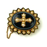 A VICTORIAN YELLOW METAL, ENAMEL AND SEED PEARL OVAL MOURNING BROOCH Edged with seed pearls and