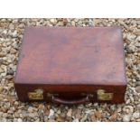 A VINTAGE TAN LEATHER BRIEFCASE With polished brass locks. (46cm x 34cm x 15cm)