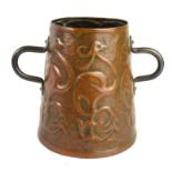 AN ARTS & CRAFTS PERIOD COPPER TWIN HANDLED JUG Embossed on border with six stylised flowerings,