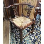 AN 18TH CENTURY YEW WOOD CORNER CHAIR With pierced vase splats and turn rails, rush seat and