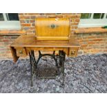 AN EARLY 20TH CENTURY MAHOGANY CASED SINGER SEWING MACHINE On a cast iron treadle base. (88cm x 41cm