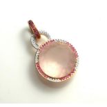 AN 18CT GOLD, ROSE QUARTZ, DIAMOND AND GEM SET PENDANT The round faceted cut rose quartz edged