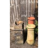 FOUR ANTIQUE CHIMNEY POTS Three of cannon barrel form, thrown stone and terracotta. (largest 78cm)