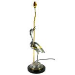 A POLISHED PEWTER AND BRASS INLAID TABLE LAMP IN THE FORM OF A CRANE On a circular ebonised base. (