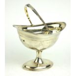 A GEORGIAN IRISH SILVER SUGAR BASKET Classical form with engraved floral swags and central