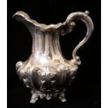 AN EARLY VICTORIAN SILVER CREAM JUG Scrolled acanthus leaf decoration to handle and body on four