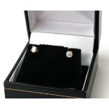 A PAIR of 18CT GOLD AND DIAMOND STUD EARRINGS Each set with a round cut diamond, in a fitted