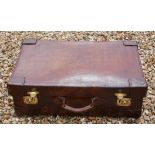 A VINTAGE TAN LEATHER SUITCASE Impressed with initials 'J.M.' and old labels, polished brass lever