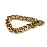 AN EARLY 20TH CENTURY 9CT GOLD BRACELET With heart form clasp and engraved pierced links. (approx