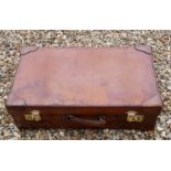 A VINTAGE TAN LEATHER SUITCASE Impressed with the initials J.S.M., polished brass lever locks. (71cm