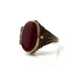 A VINTAGE WHITE METAL AND CARNELIAN LADIES' SNUFF/POISON RING The oval cut carnelian stone set to