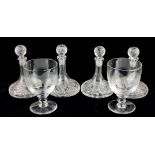 A SET OF FOUR CUT LEAD CRYSTAL SMALL DECANTERS With spherical stoppers, geometric form cuts and