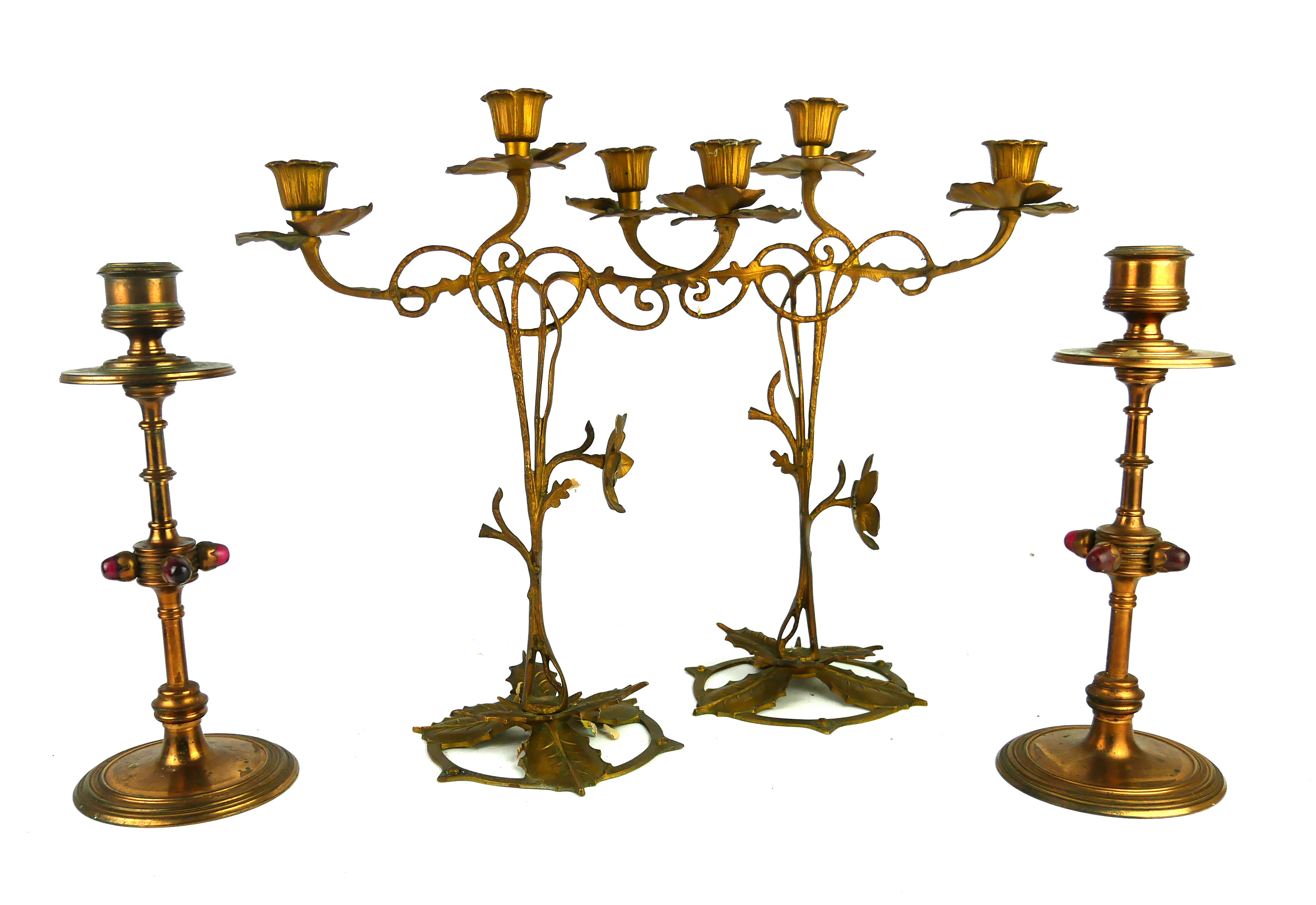 A PAIR OF 19TH CENTURY GOTHIC REVIVAL BRASS AND RED GLASS CIRCULAR CANDLESTICKS Each set with four