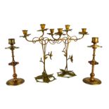A PAIR OF 19TH CENTURY GOTHIC REVIVAL BRASS AND RED GLASS CIRCULAR CANDLESTICKS Each set with four