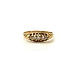 AN EARLY 20TH CENTURY 18CT GOLD AND DIAMOND FIVE STONE RING The row of graduated stones in a pierced