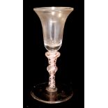 A GEORGIAN PINK AND WHITE AIR TWIST GLASS With plain flared bowl and spiral glass twist to stem. (