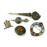 A COLLECTION OF THREE VICTORIAN WHITE METAL AND HARDSTONE CELTIC BROOCHES Including a brooch set