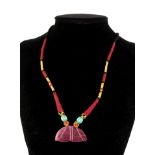 A MOGHUL DESIGN YELLOW METAL, RUBY AND DIAMOND PENDANT NECKLACE The carved leaf form pendant