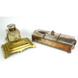 AN EARLY 20TH CENTURY SILVER PLATE ON COPPER RECTANGULAR INKSTAND With serpentine lid, twin mask