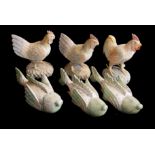 A COLLECTION OF SIX CARVED WOODEN ANIMAL SCULPTURES Comprising three roosters and three exotic fish.