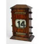 AN EDWARDIAN OAK PERPETUAL RECTANGULAR DESK CALENDAR CLOCK With three calendar windows and