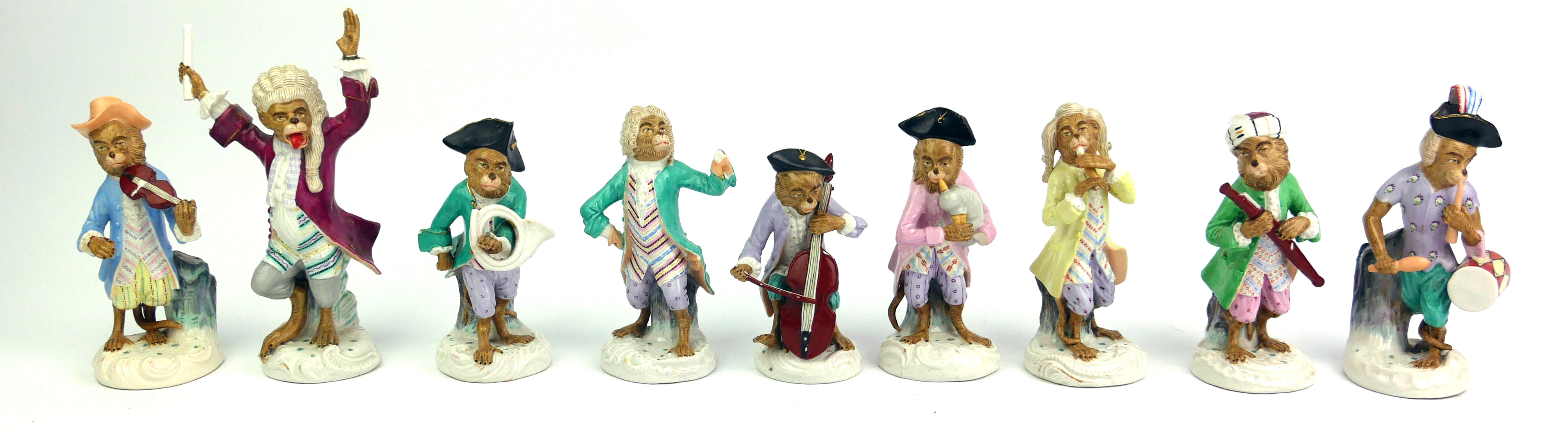 A SET OF NINE 19TH CENTURY GERMAN PORCELAIN MONKEY BAND FIGURES A conductor with various musicians