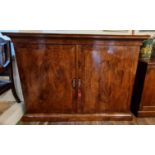 A 19TH CENTURY MAHOGANY DWARF LINEN PRESS With two brass banded doors enclosing slides. (103cm x