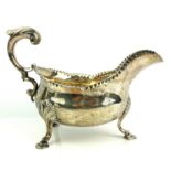A GEORGIAN SILVER SAUCE BOAT Heavy gauge with gadrooned decoration and tripod feet, hallmarked
