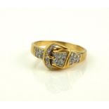 AN 18CT GOLD AND DIAMOND 'BUCKLE' RING Having pavé set diamonds (size T).