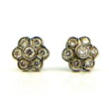 A VINTAGE PAIR OF 18CT WHITE GOLD AND DIAMOND CLUSTER EARRINGS Each set with an arrangement of round