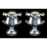 A PAIR OF SILVER PLATED CHAMPAGNE COOLERS Urn form with twin handles and decorated with vine
