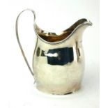 A GEORGIAN SILVER CREAM JUG Classical helmet form with reeded edge, hallmarked London, 1799. (approx