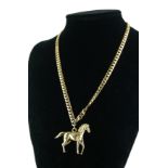 A 9CT GOLD EQUESTRIAN PENDANT NECKLACE The heavy gauge gold horse pendant in standing pose, on a