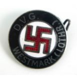 A GERMAN WORLD WAR II ENAMEL SWASTIKA LAPEL CIRCULAR BADGE Marked 'NSDAP DVG Westmark Lothr'. (