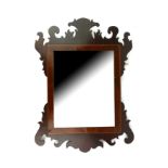 AN EARLY 19TH CENTURY MAHOGANY AND BEVELLED GLASS MIRROR Carved frame with rectangular bevelled