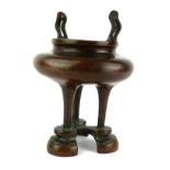 A CHINESE BRONZE SPHERICAL CENSER Impressed mark Ying Yang to base, on tripod legs. (approx 17cm)