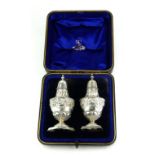 A MATCHED PAIR OF VICTORIAN SILVER PEPPERETTES Classical form, hallmarked London, 1895 and 1896,