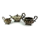 A VICTORIAN IRISH SILVER TEA SET Comprising a teapot, sugar basin and cream jug, fluted melon form